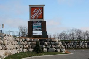 Signage and large boulder retaining wall